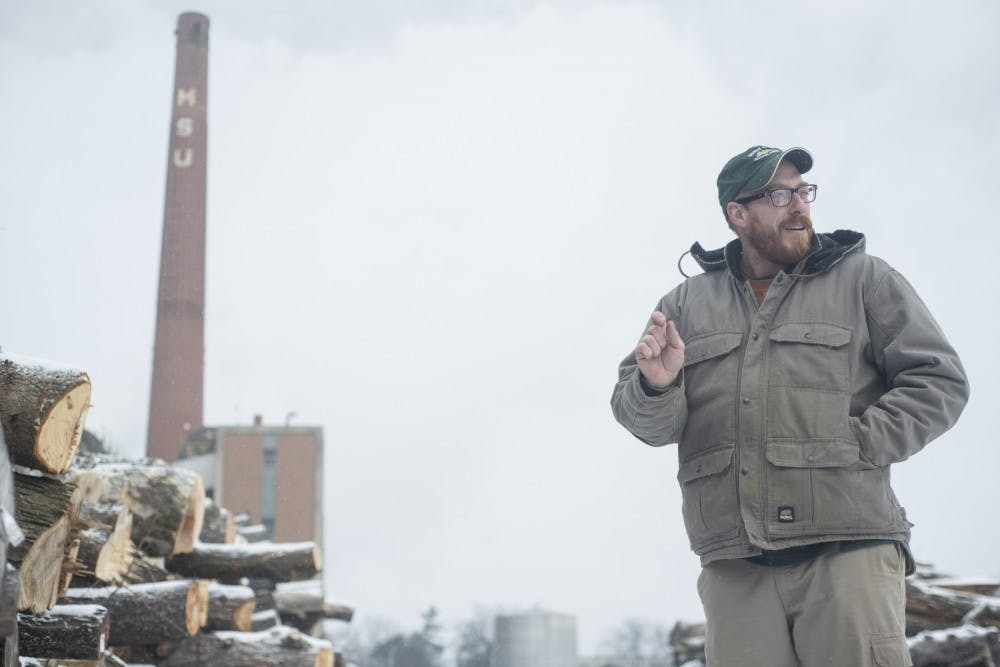 Wood recovery specialist Dan Brown shares his experiences with the log yard and wood categorization during an interview on Feb. 12, 2016 behind the MSU Surplus Store and Recycling Center.