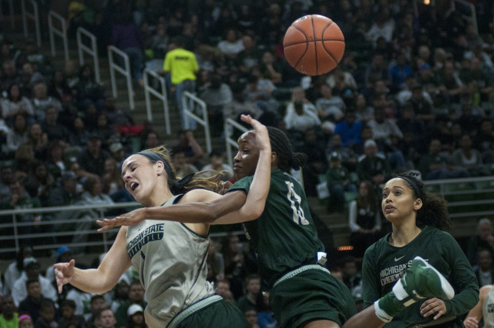 Senior guard Tori Jankoska (1) goes for a layup but is disrupted by junior guard Morgan Green (13) during Michigan State Madness on Oct. 14, 2016 at Breslin Center. 