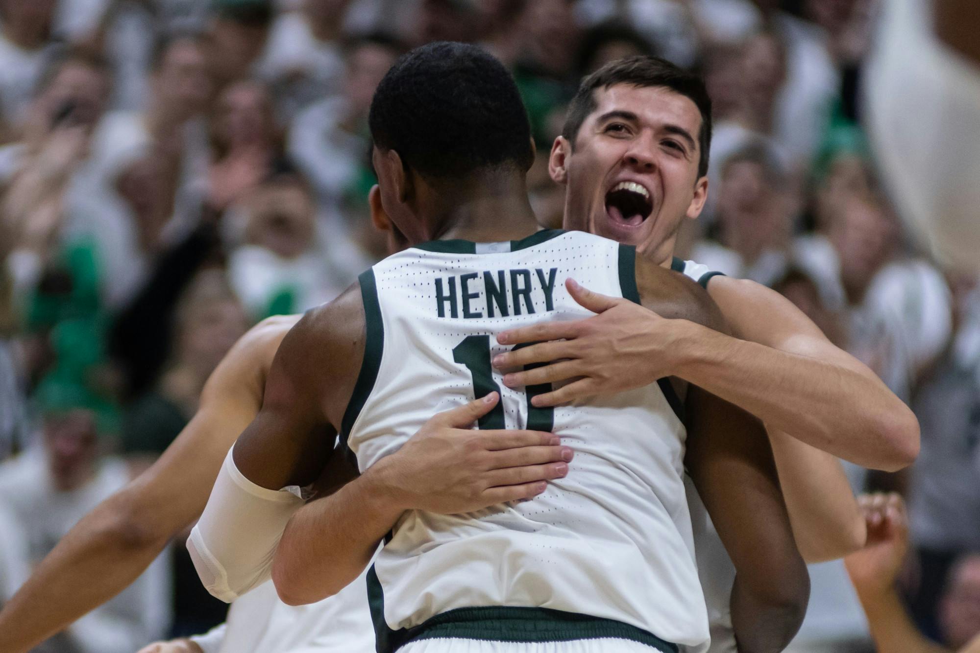 Senior forward Conner George (right) hugs sophomore forward Aaron Henry (11).The Spartans defeated Michigan, 87-69, at the Breslin Student Events Center on January 5, 2020. 