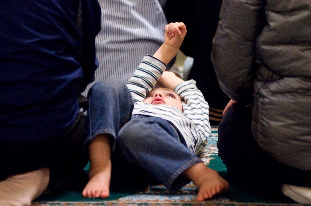 	<p>East Lansing resident AbdUllah Al-Mohidat, 3, entertains himself while his father and other worshipers finish the fourth prayer of the day Monday at the Islamic Center of East Lansing, 920 S. Harrison Road. After the regular prayer the president of the center held a special remembrance for those that lost their lives in the September 11 attack, and also to welcome the Osama bin Laden&#8217;s death.</p>