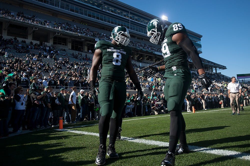 <p>Junior defensive lineman Lawrence Thomas, 8, talks with junior defensive end Shilique Calhoun before the game against Michigan on Oct. 25, 2014, at Spartan Stadium. The Spartans defeated the Wolverines, 35-11. Julia Nagy/The State News</p>