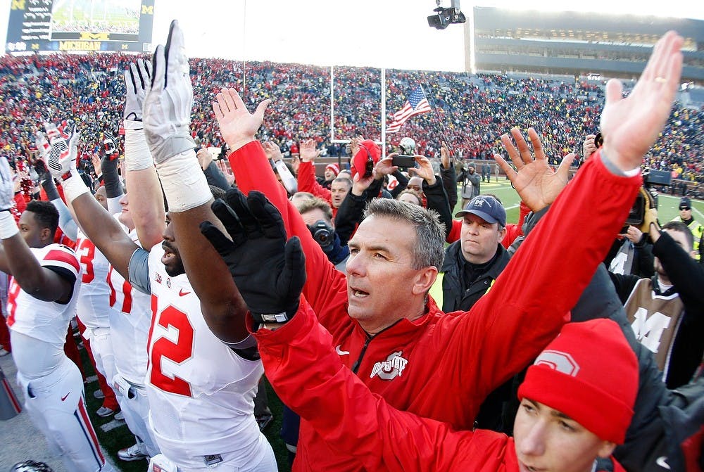 	<p>Ohio State head coach Urban Meyer joins his team to sing the school&#8217;s alma mater &#8220;Carmon Ohio&#8221; at the end of the game against the Michigan Wolverines at Michigan Stadium in Ann Arbor, Mich., on Saturday, Nov. 30, 2013. Ohio State won, 42-41. Julian H. Gonzalez/Detroit Free Press/MCT</p>