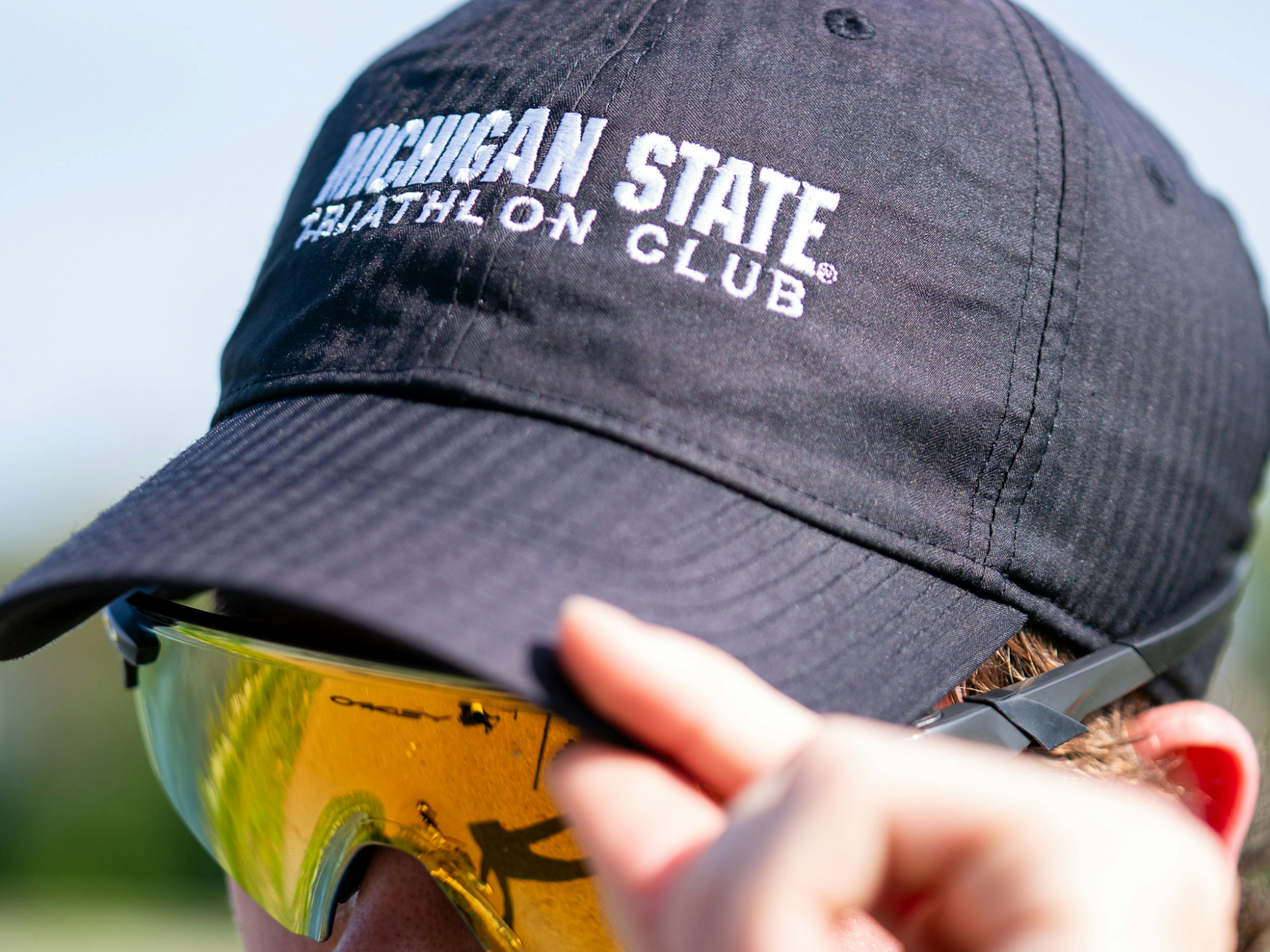Michigan State University senior Jackson Harrell shows off his club gear after a practice session at MSU on May 16, 2024. 