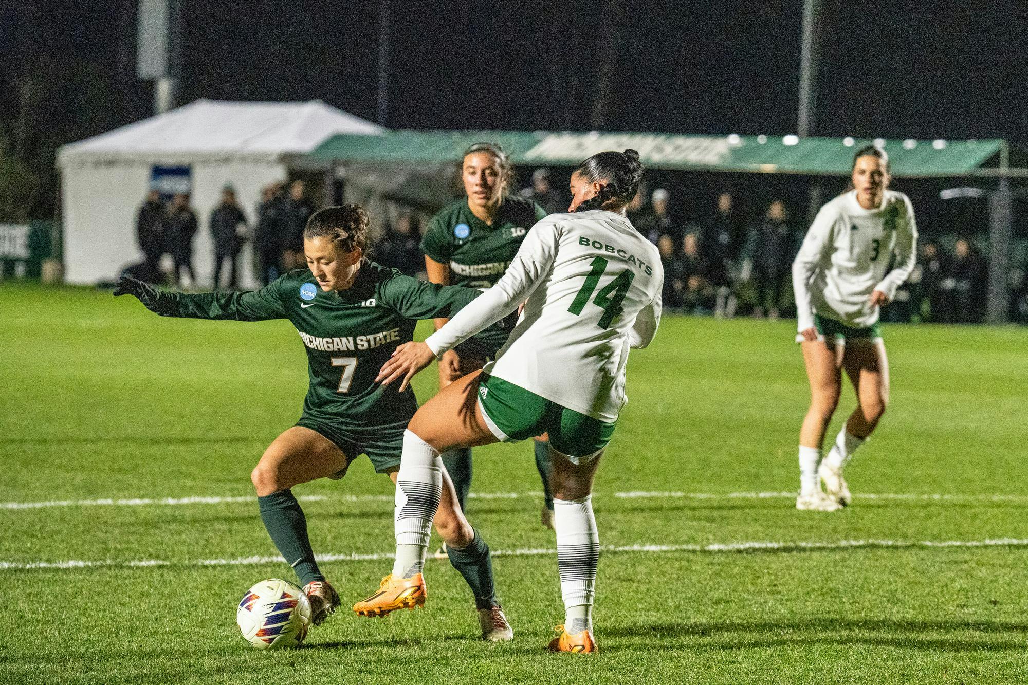 <p>Michigan State University senior midfielder Gabby Mueller (7) weaving around Ohio University graduate student defender Ella Bianco (14) <span class="ql-cursor">﻿</span>at the NCAA first tournament at DeMartin Soccer Complex on Nov. 10th, 2023. </p>