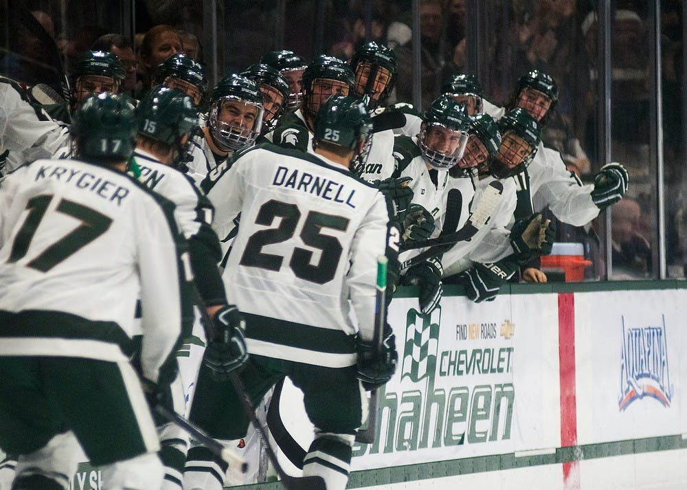 <p>The Spartan bench celebrates a goal by Brent Darnell during the game against Minnesota on Dec. 6, 2014, at Munn Ice Arena. The Spartans tied the Golden Gophers, 3-3, but won the extra point in a shootout. Danyelle Morrow/The State News</p>
