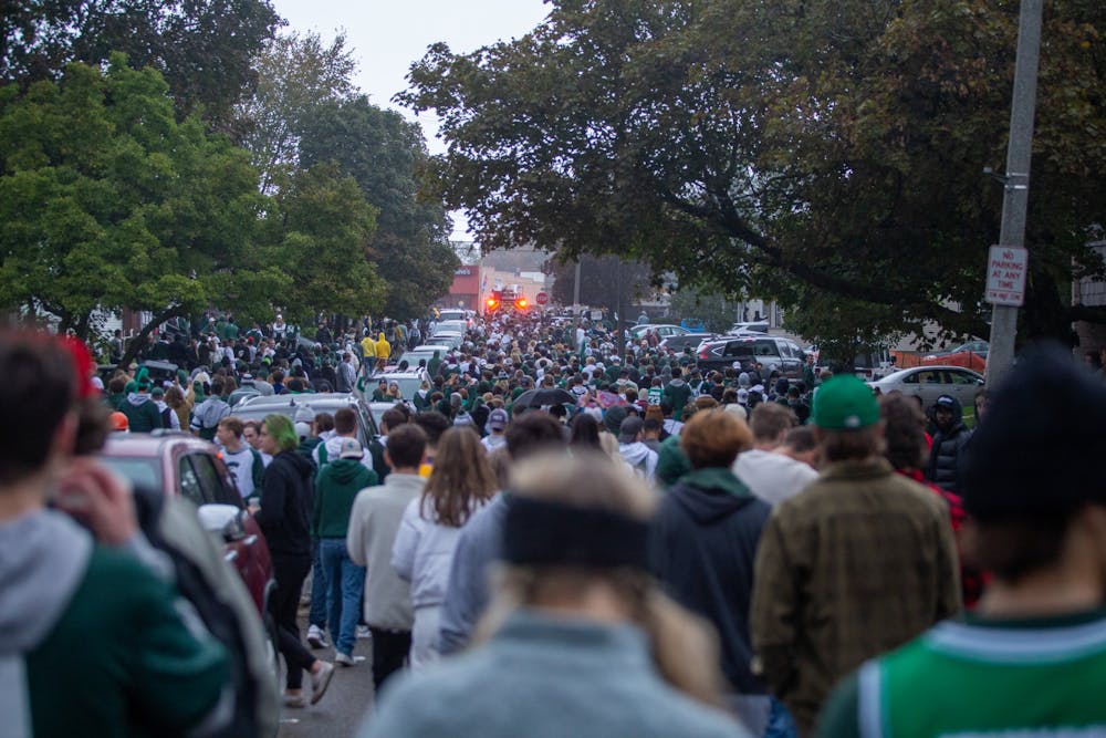 <p>The streets flood with fans from apartments and tailgates after MSU's football victory over the University of Michigan on Oct. 30, 2021.</p>