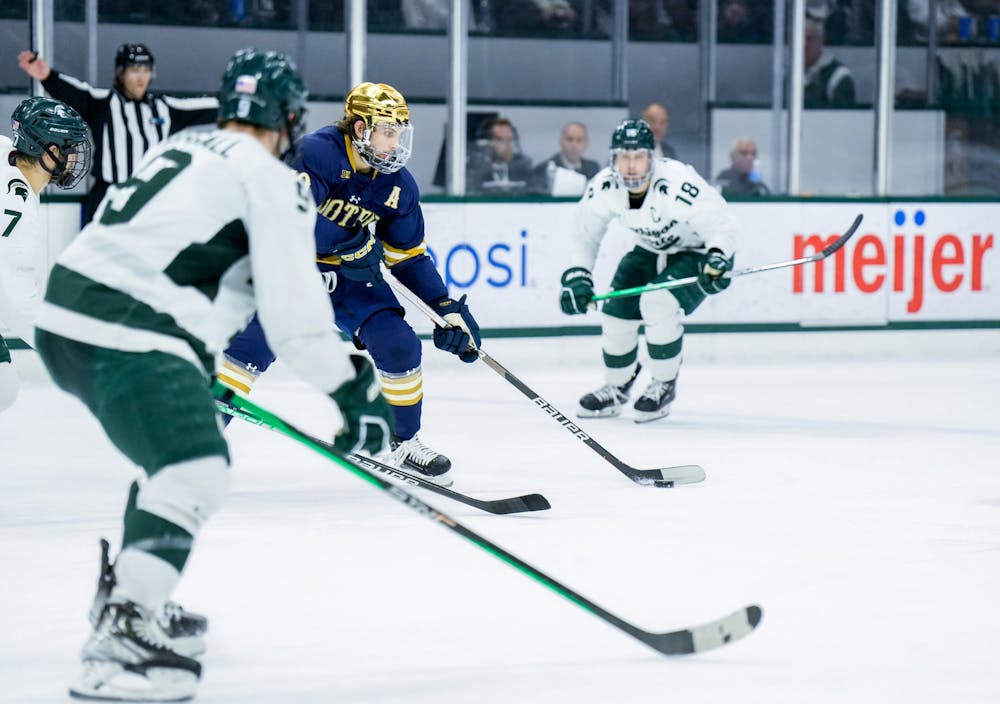 <p>Notre Dame's junior forward Landon Slaggert (19) dribbles the puck during a game against MSU at Munn Ice Arena on Feb. 3, 2023. The Spartans defeated the Fighting Irish 3-0.</p>