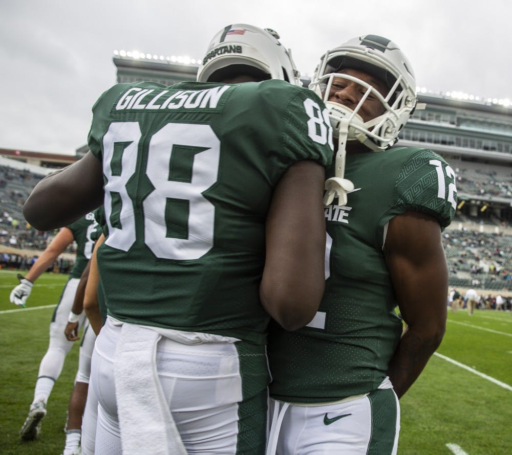 Redshirt freshman Trenton Gillison (88) and redshirt freshman Chris Jackson (12) before the homecoming game against Indiana on Sept. 28, 2019 at Spartan Stadium. 