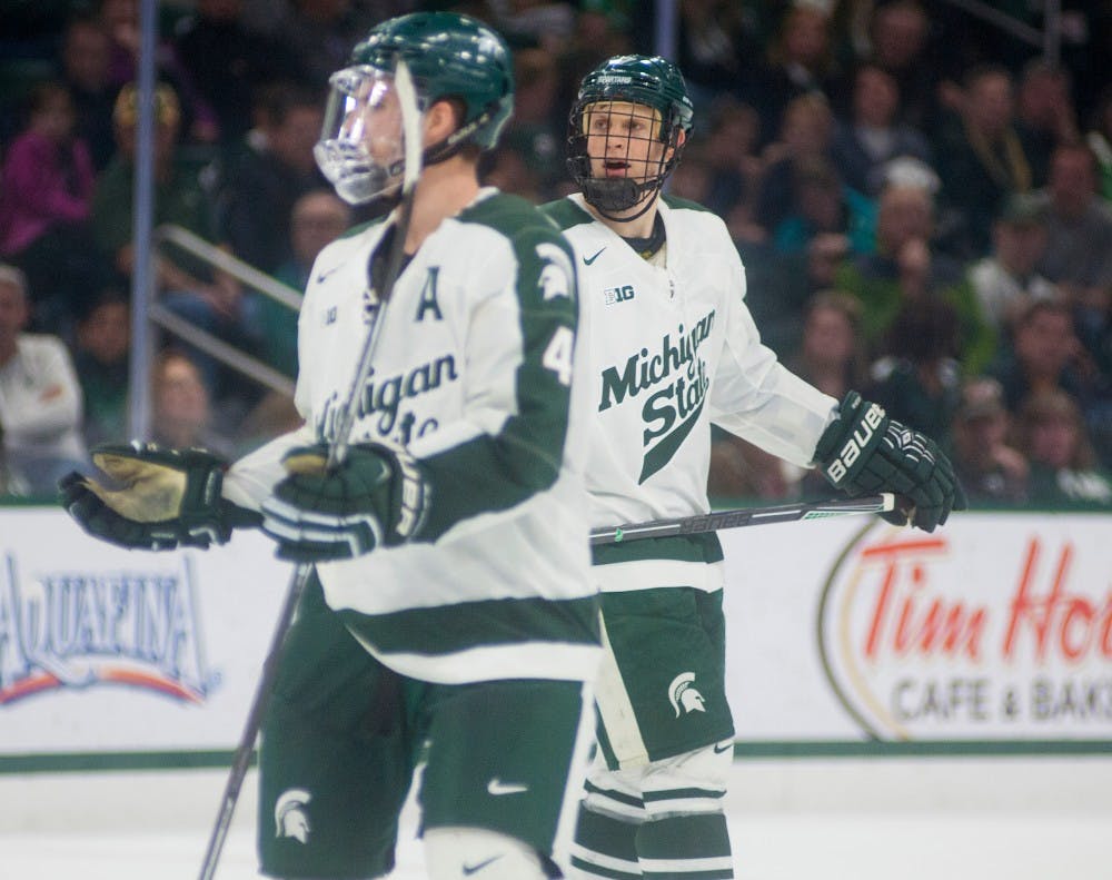 Senior defenseman Travis Walsh, 4, and senior defenseman John Draeger react to a call during the third period of the game against Wisconsin on Dec. 12, 2015 at Munn Ice Arena. The Spartans were defeated by the Badgers, 3-0.
