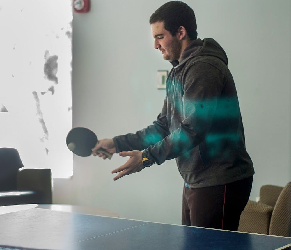 <p>Economics freshman Raffi Hulian shows off his table tennis skills Sunday afternoon in Akers Hall. Kayla Clarke/ The State News.</p>