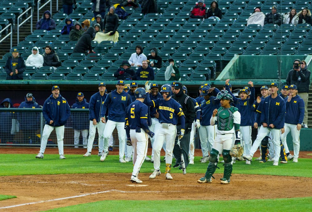 <p>Michigan celebrating with Michigan graduate student center fielder Joe Stewart (5) after he ran home scoring another point for Michigan. Michigan State lost 18-6 to Michigan on April 15, 2022  at the Lugnut Stadium.</p>