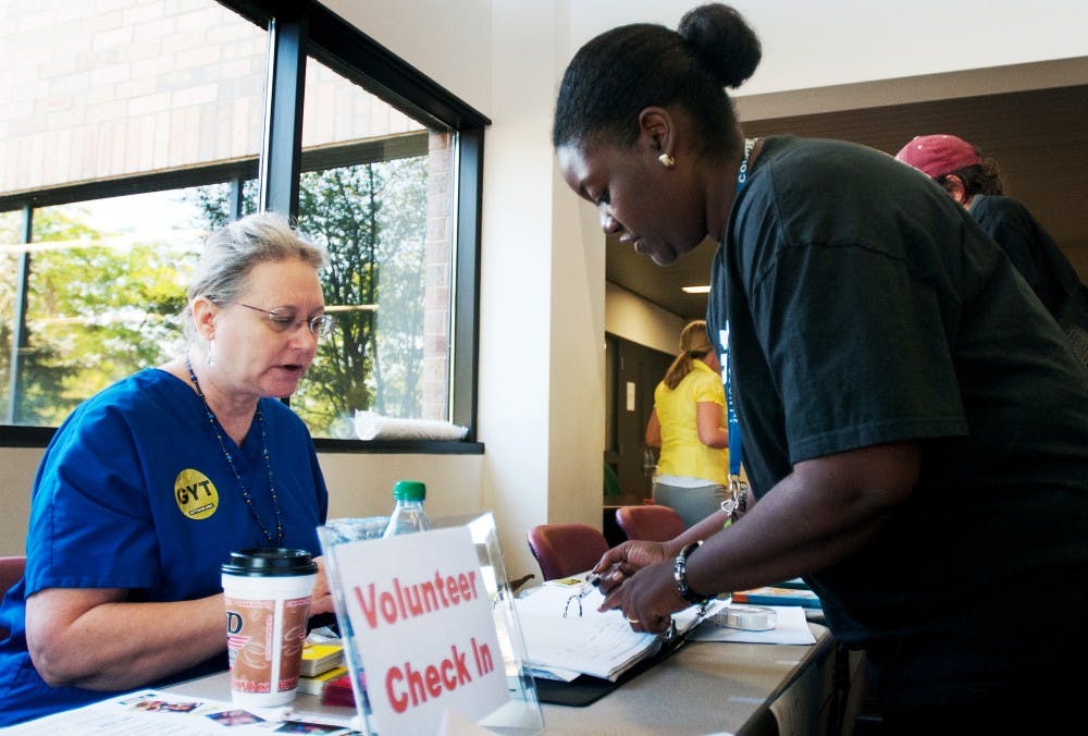 Kathy Nigro, left, a registered nurse at the Ingham County Health Department talks with Vennishia Smith, right, HIV/STD prevention coordinator for Ingham County Health Department, while volunteering at the health department, 5303 S. Cedar St. in Lansing, on National HIV Testing Day. On Wednesday morning, the health department offered free and confidential STD and HIV testing.  Samantha Radecki/The State News