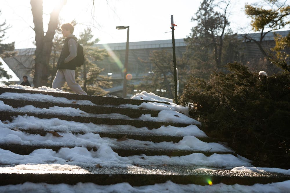 <p>A student walks past the steps outside Wells Hall as the sun shines in the background on Feb. 16, 2026, in East Lansing, Michigan.</p>