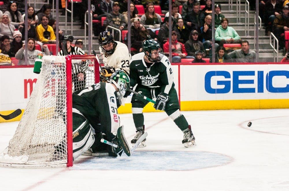 Spartans block the puck during the game against Michigan Tech on Jan. 1, 2018, at Little Caesars Arena.  The Spartans fell to the Huskies 5-2.  
