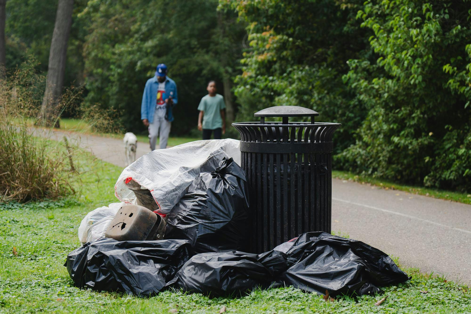 Trash piles up near the Red Cedar River on Sept. 21, 2024. The Michigan Water Stewardship Program hosted a river trail cleanup on Saturday 9/21 at Potter Park Zoo.