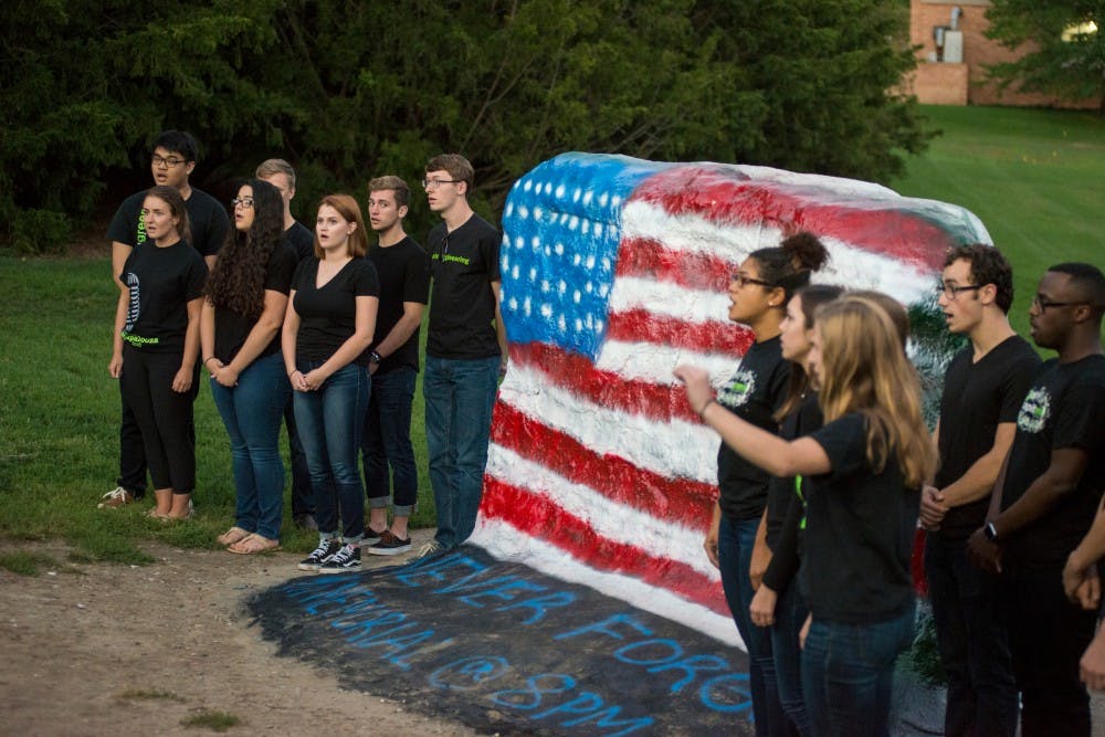 MSU Capital Green sings the national anthem on Sept. 11. 2016 at the rock on Farm Lane. MSU College Democrats and MSU College Republicans held a memorial for the 15th anniversary of the terrorist attacks that occurred on Sept. 11, 2001.