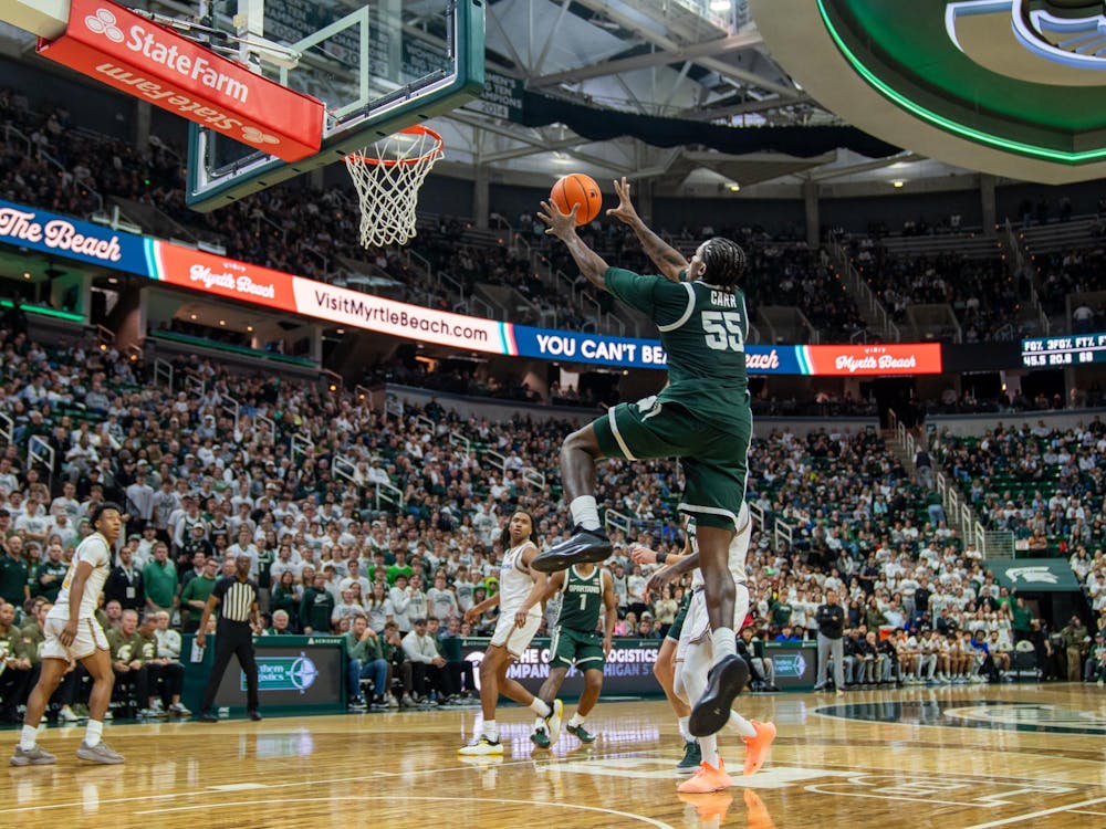 <p>Michigan State's forward and junior Coen Carr (55) catches a pass from Jeremy Fears Jr. (1) and prepares to dunk versus San Jose State at the Breslin Center in East Lansing, Michigan on Thursday, Nov. 13, 2025.</p>