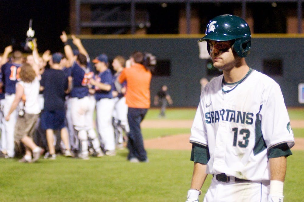 	<p>Junior shortstop Justin Scanlon walks past Illinois players as they celebrate their win Saturday at Huntington Park in Columbus, Ohio. Scanlon&#8217;s fly ball was caught, giving <span class="caps">MSU</span> their third out and ending the Big Ten Tournament Championship game with a final score of 9-1.</p>