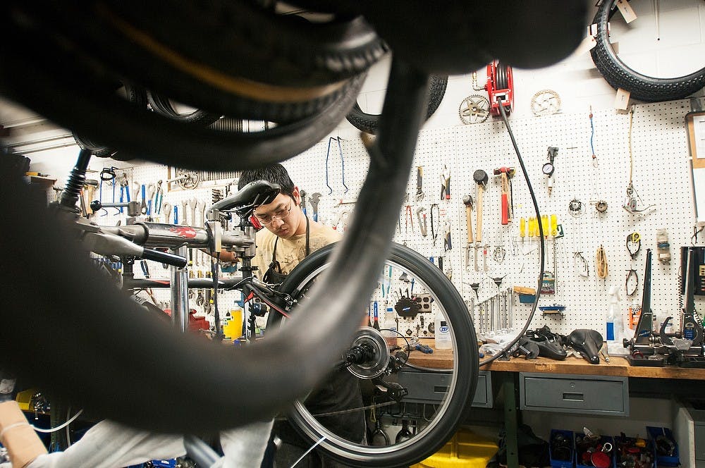 	<p><span class="caps">MSU</span> Bikes Service Center employee Bruce Ngo works on a bike May 16, 2013. Ngo has been working at the center since February. Julia Nagy/The State News</p>