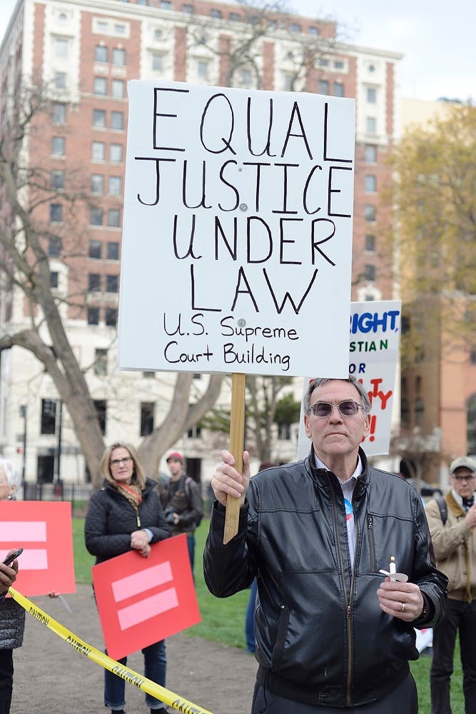 <p>Kalamazoo resident Lorence Wenke stands to support same-sex marriage April 27, 2015, at the Lansing Capit0l. The vigil was held in anticipation of the same-sex marriage trials in the U.S. Supreme Court. Hannah Levy/The State News</p>