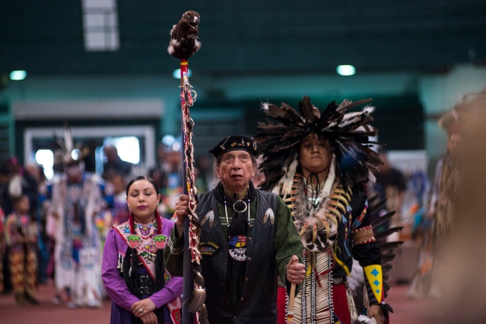 From left, head female Iliana Bennett, head veteran George Martin and head male Olin Yazzie wait for the next pow wow to begin on April 9, 2016 at the Jenison Field House. This event was put on by North American Indigenous Student Organization which strives to promote education and motivate the Native Student Community at MSU.