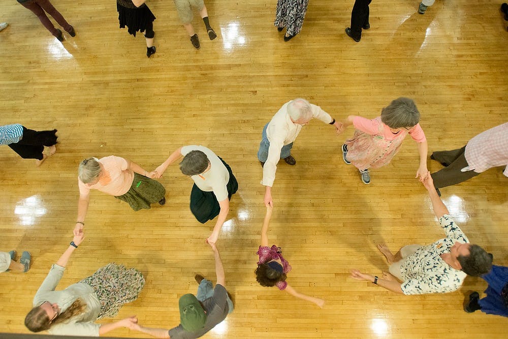 	<p>Attendees square dance Saturday at Lansing Central United Methodist Church. The dance event was held by Ten Pound Fiddle, an organization of volunteers that presents concert and dance series. Julia Nagy/The State News</p>