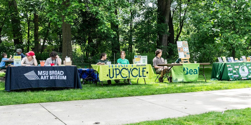 <p>Tables from different MSU groups are set up to inform attendees at the Music and the Garden event about their efforts towards helping the environment in East Lansing, Mich., on June 28, 2026.</p>