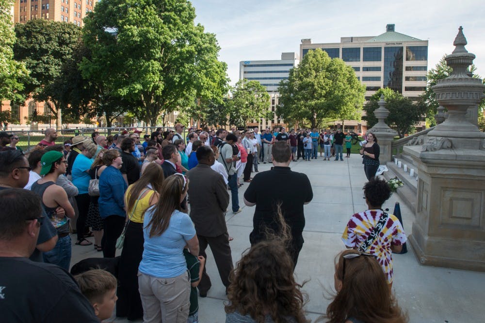 Haslett, Mich. resident Alysa Hodgson, right, speaks to a gathering of people during the candlelight vigil for Orlando on June 12, 2016 at the Capitol in Lansing. Lansing Association of Human Rights hosted the vigil for people that wanted to gather and mourn for Orlando's victims of violence.
