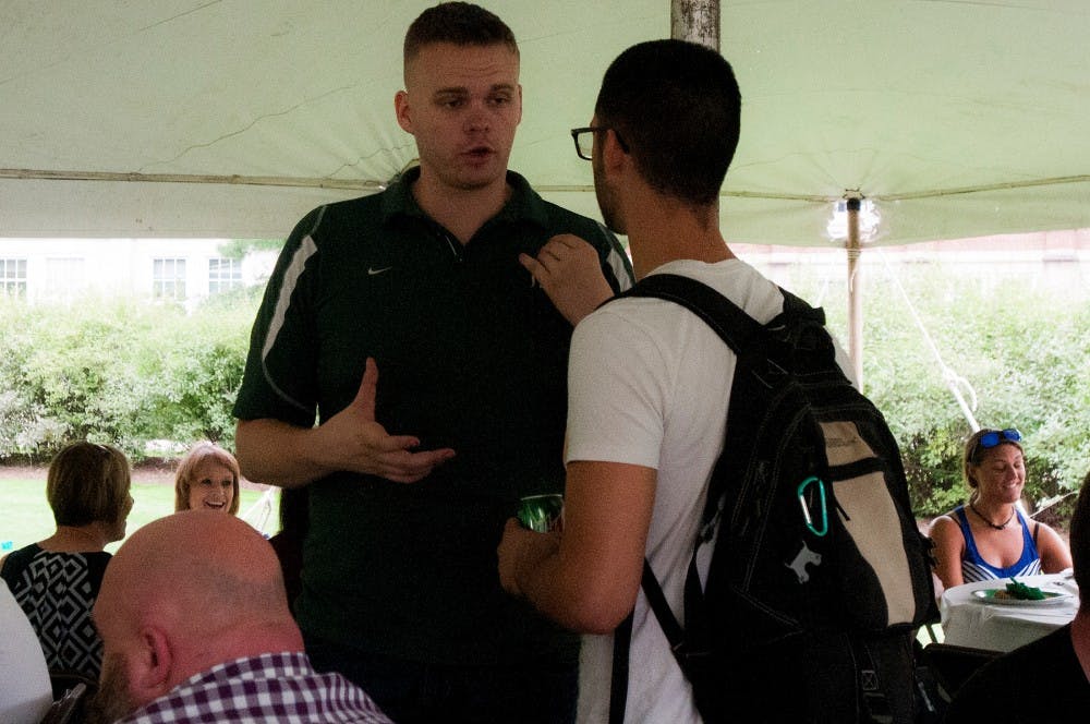 Supply chain management senior Kyle Kissinger, left, talks to a guest during the Fall Veterans Welcome Picnic on Sept. 22, 2016 at the Student Services courtyard.  Kissinger is the president of MSU Student Veterans of America. 