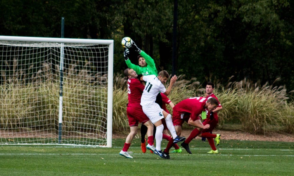 Junior forward Ryan Sierakowski (11) tries to head the ball during the game against Indiana on Oct. 29, 2017, at DeMartin Stadium. The Spartans and the Hoosiers tied 1-1 in double overtime.