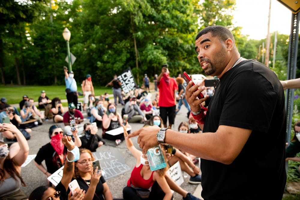 Paul Birdsong calls Lansing Mayor Andy Schor after another protestor handed Birdsong the mayor's number. The protestors marched two miles from the Capitol to the mayor's house June 6, 2020.