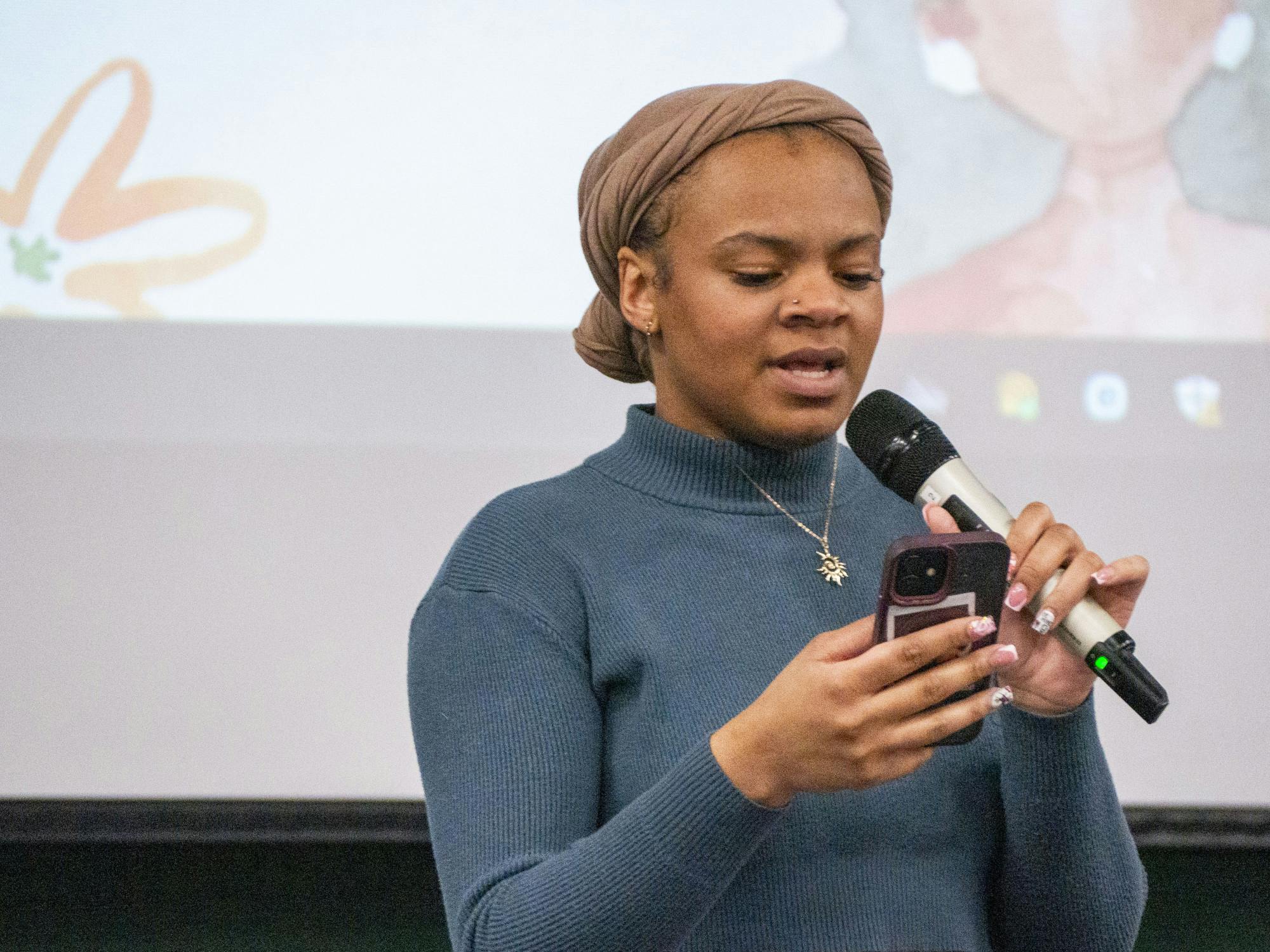 Psychology and cognitive science junior Ada Johnson recites original poetry and music at the UAB Open Mic Night and Storytelling: Black Voices event in the McDonel Kiva on Feb. 24, 2025. The open mic night featured poetry, music and comedy, with many performers speaking about issues of inclusion and racism for the black community. 