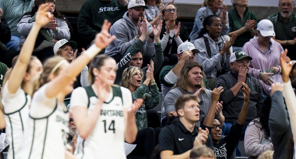 <p>Michigan State fans and women's basketball players cheer after the Spartans score against the Golden Grizzlies at the Breslin Student Events Center in East Lansing, Mich., on Nov. 23, 2025.</p>