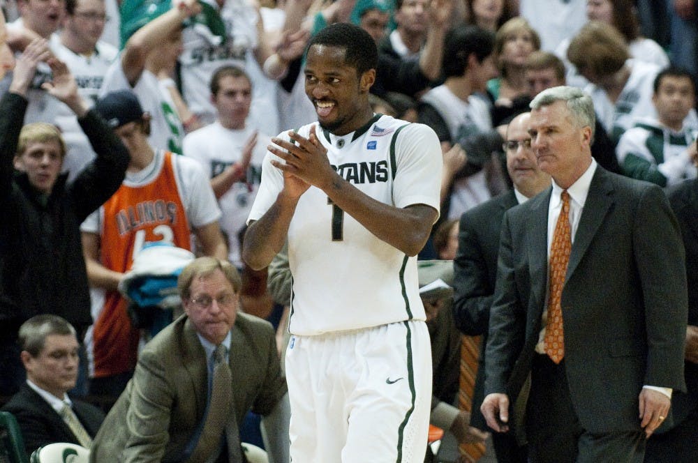 As time expires, senior guard Kalin Lucas walks past a dejected Illnois head coach Bruce Weber. Lucas lead the Spartans with 25 points on their way to a 61-57 victory over the Fighting Illini. Josh Radtke/The State News