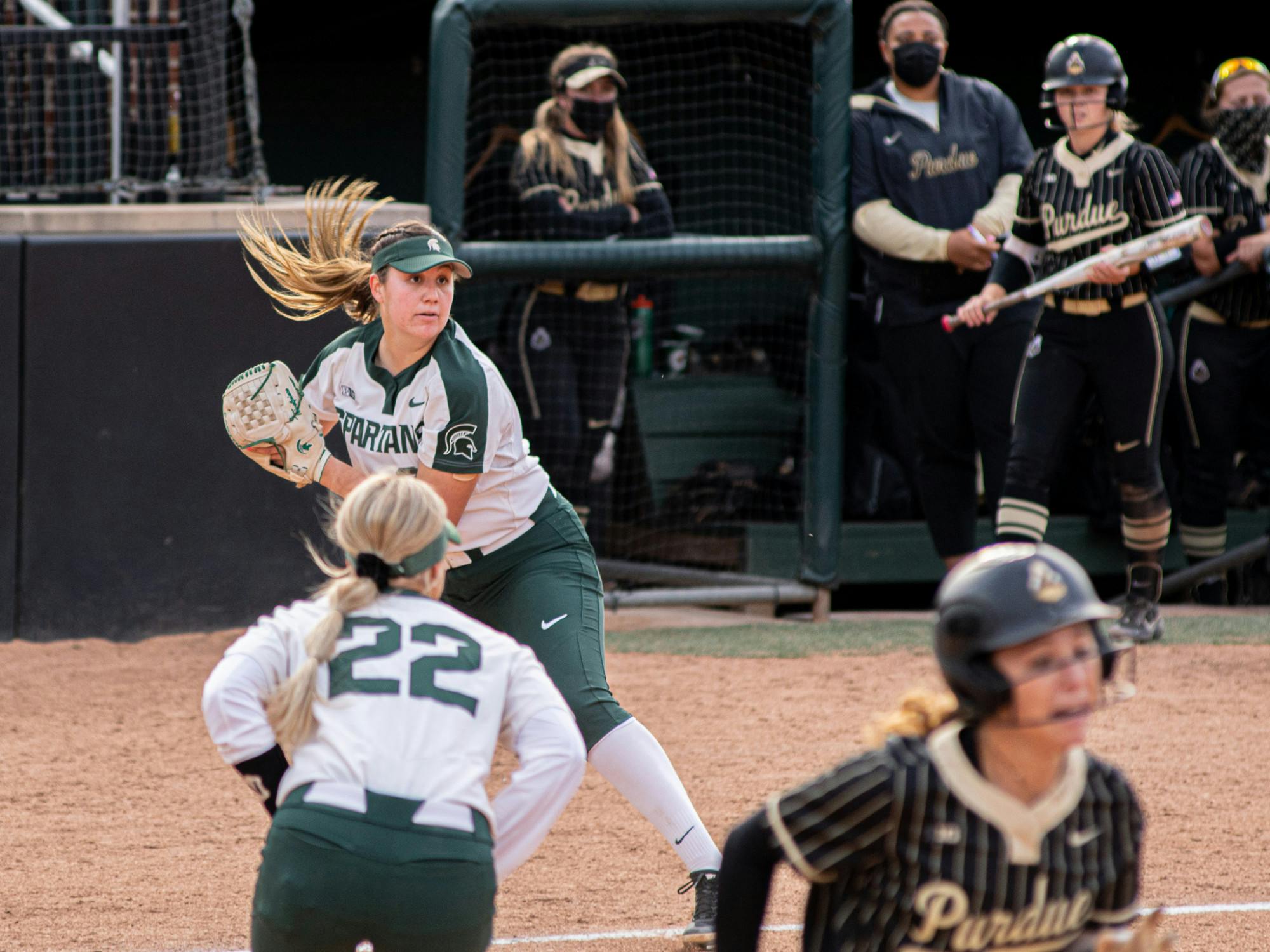 Michigan State freshman Alexis Barroso looks to throw to first and secure a double-play, after catching a pop-up near home on April 23, 2021. The Spartans fell to Purdue 8-7.