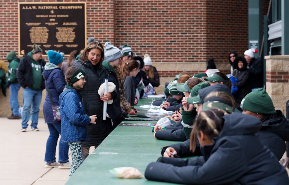 <p>Michigan State softball players stay after the game to sign posters and meet the fans. Spartans lost 6-0 against Nebraska, on April 9, 2022.</p>