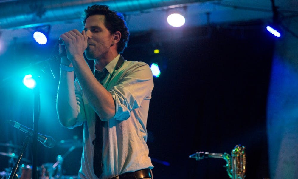 <p>Saxophonist and vocalist George Falk sings during a performance with the band Desmond Jones on Oct. 2, 2015, at The Loft, 414 East Michigan Ave., in Lansing. Desmond Jones is a local band that is currently on tour in Michigan, Ohio and Illinois.</p>