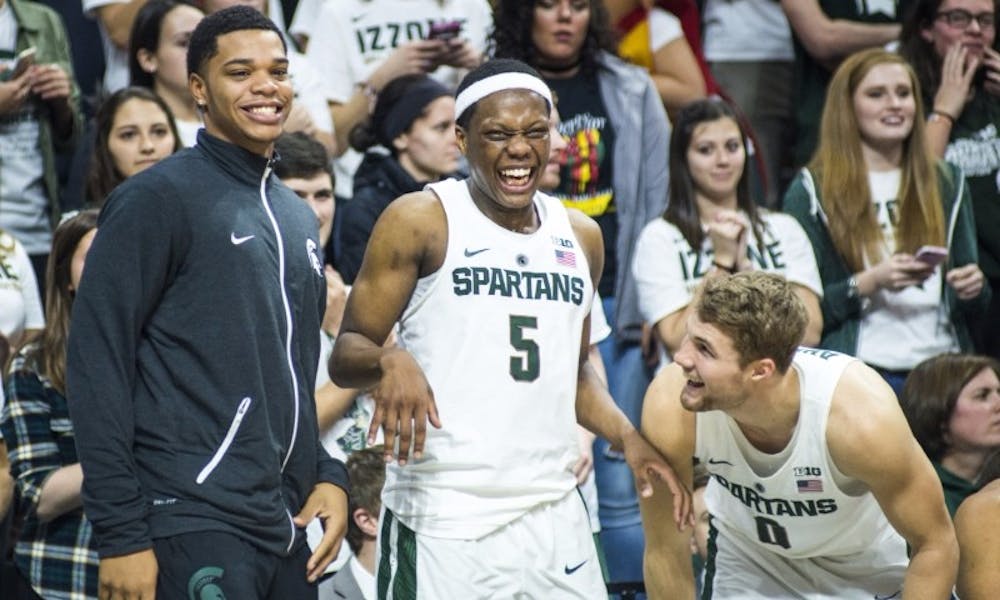 Freshman guard Miles Bridges (22), freshman guard Cassius Winston (5) and sophomore guard Kyle Ahrens (0) celebrate during the second half of the men's basketball game against Youngstown State on Dec. 6, 2016 at Breslin Center. The Spartans defeated the Penguins, 77-57.