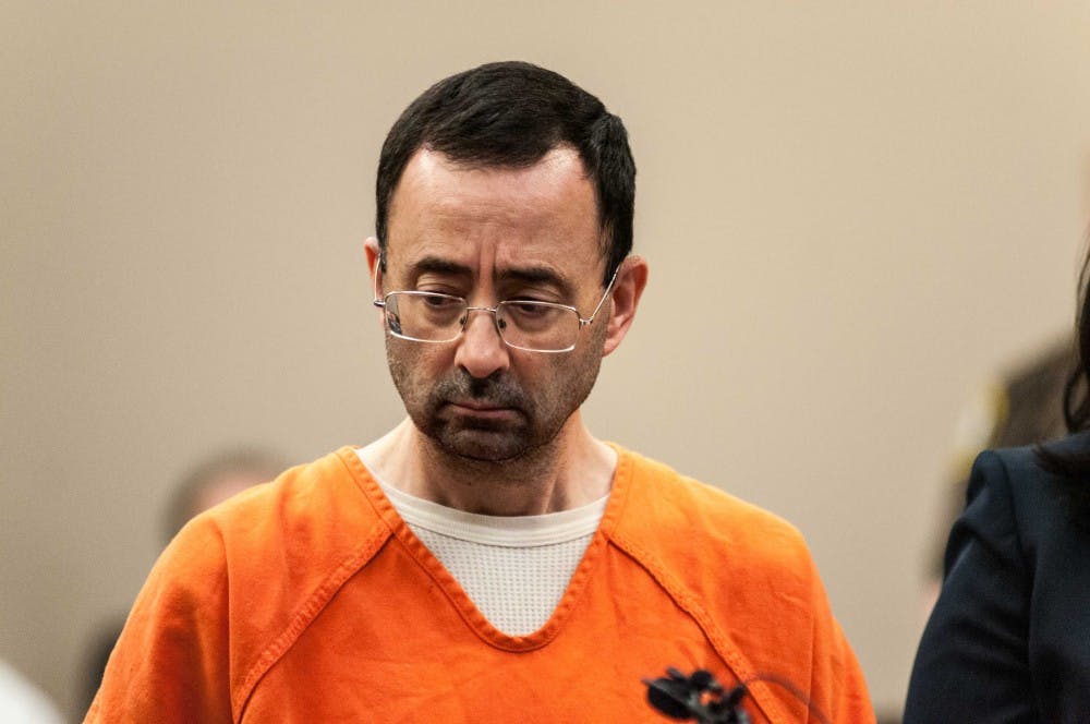 <p>Larry Nassar listens as prosecution reads his plea deal during the plea hearing on Nov. 22, 2017, at the Veterans Memorial Court at 313 W Kalamazoo St., Lansing. Nassar pleaded guilty to seven counts.</p>