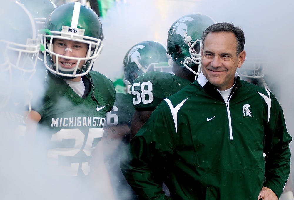 <p>Senior wide receiver Blair White, left, and head coach Mark Dantonio stand with the team before running out onto to the field to start on Nov. 21, 2009, against Penn State at Spartan Stadium. The Spartans were defeated by the Nittany Lions 42-14. Angeli Wright/The State News</p>