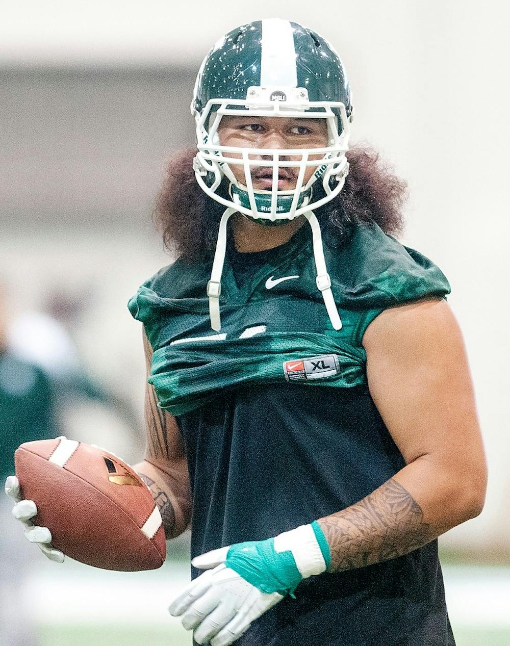 	<p>Senior offensive tackle Fou Fonoti holds the football during a practice session, Tuesday, March 19, 2013, at Duffy Daugherty Football Building. Julia Nagy/The State News</p>