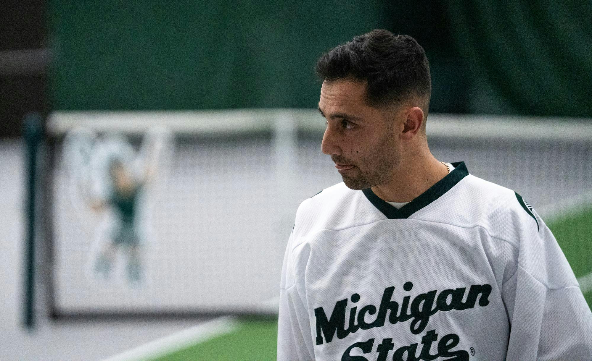 <p>Michigan State Tennis head coach Harry Jadun walks across the court at the MSU Tennis Facility on Mar. 12, 2025</p>