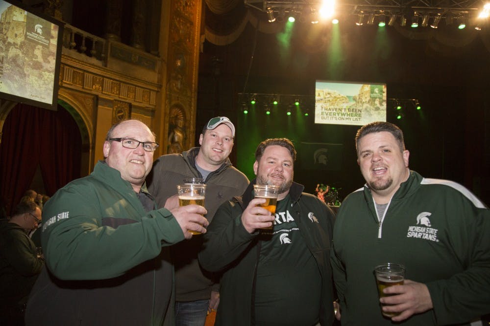 <p>From left, Jim Ackerson, Richard Floyd, Scott Truman and Mike Vitale celebrate during the 2018 NCAA Spartan Pep Rally at The Fillmore in Detroit on March 16, 2018.</p>