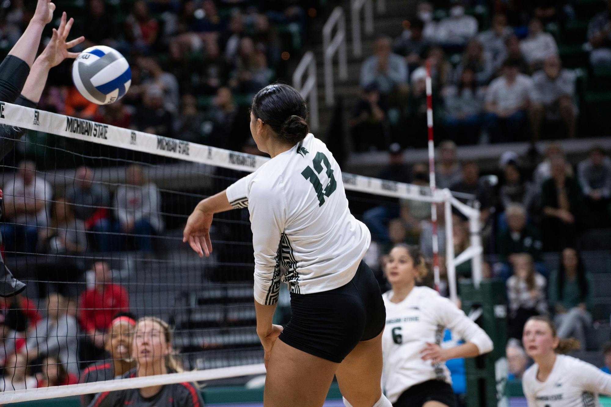 <p>Sophomore outside hitter Aliyah Moore(13) spikes the ball at the Ohio State v. MSU game held at the Breslin Center on November 5, 2022. The Spartans fell to the Buckeyes 3-0.</p>