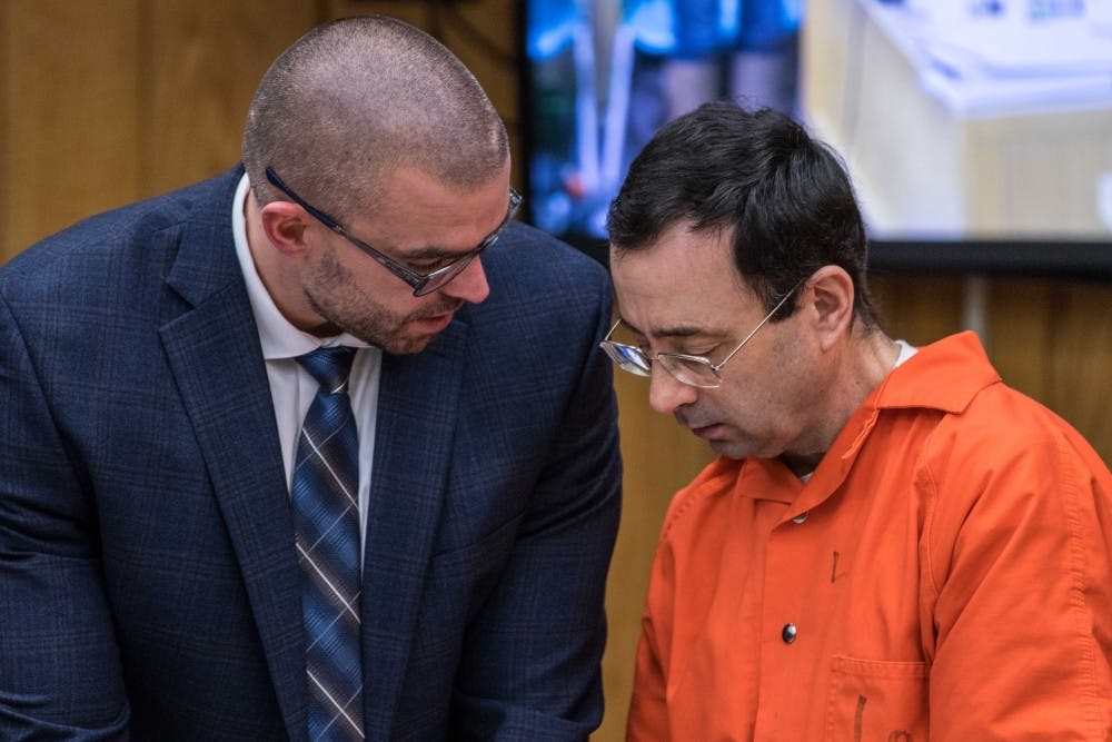 Larry Nassar and his defense attorney Matt Newburg discuss something during the first day of his sentencing on Jan. 31, 2018, in the Eaton County courtroom. Nassar faces three counts of criminal sexual conduct in Eaton County.