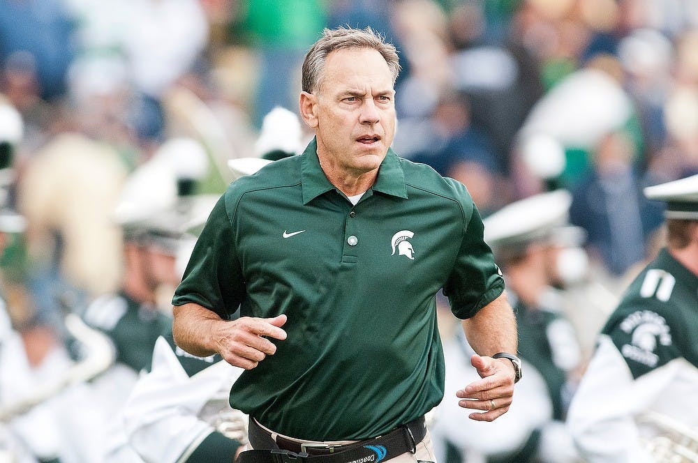 <p>Head coach Mark Dantonio heads towards the locker room at halftime, Sept. 21, 2013, at Notre Dame Stadium. The Spartans fell to the Irish, 17-13. Khoa Nguyen/ The State News</p>