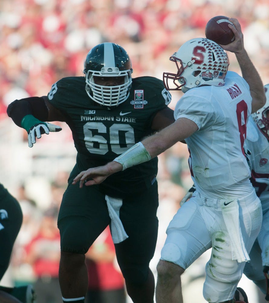 	<p>Defensive lineman Micajah Reynolds trys to tackle Stanford quarterback Kevin Hogan during the 100th Rose Bowl on Jan. 1, 2014, in Pasadena, Calif. Julia Nagy/The State News</p>