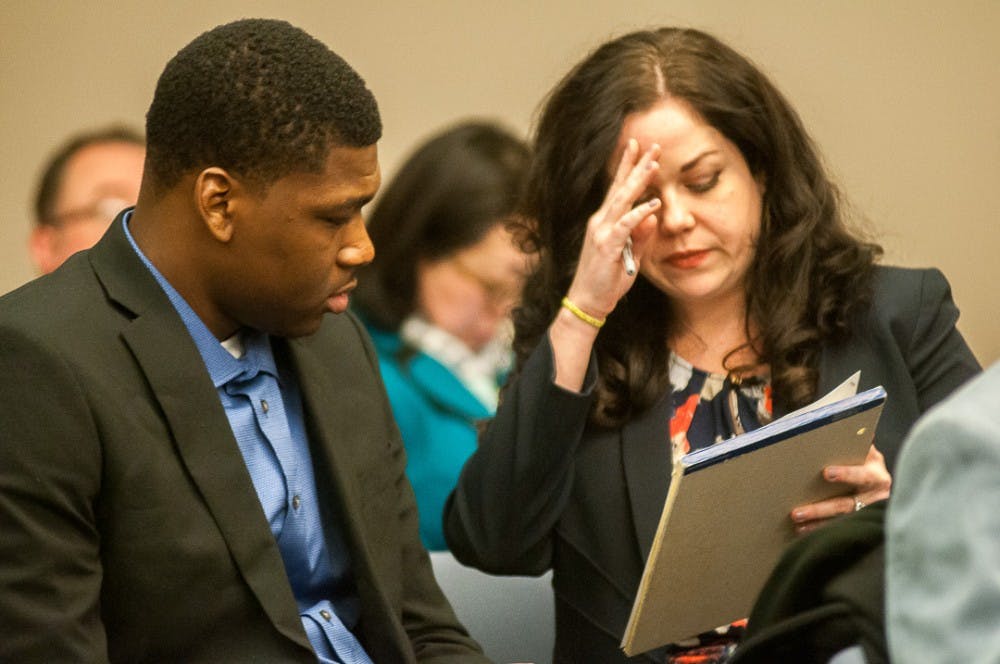 <p>Attorney Shannon Smith talks to Joshua King before the pretrial conference on April 4, 2018 at the Veterans Memorial Courthouse in Lansing</p>