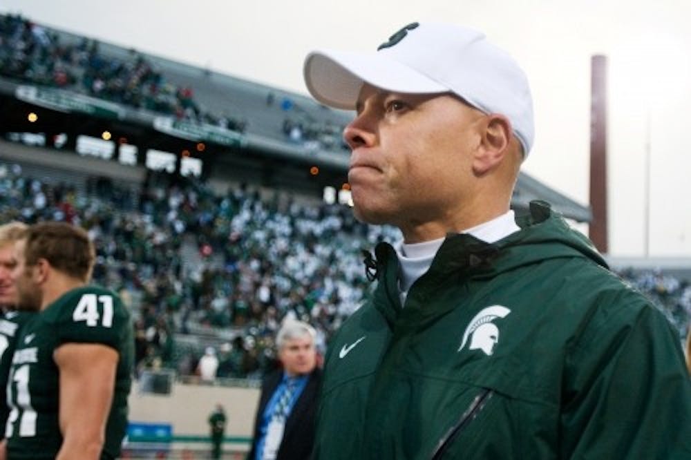 <p>Former offensive coordinator now-assistant secondary, special teams and freshman coach Don Treadwell, who stepped in for head coach Mark Dantonio, walks off the field after defeating Wisconsin 34-24 on Oct. 2, 2010 at Spartan Stadium. (Sam Mikalonis | The State News)</p>
