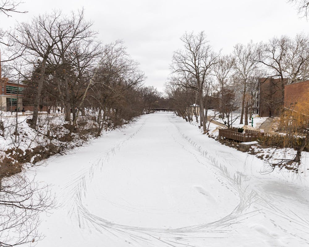 The Red Cedar River has markings in the snow covering the river in East Lansing, MI on Feb. 11, 2026.